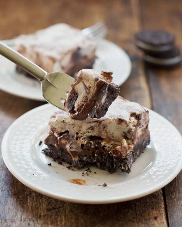 Oreo fudge ice cream bars on plates and on a fork.