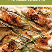 Apricot chicken on a sheet pan with charred scallions.