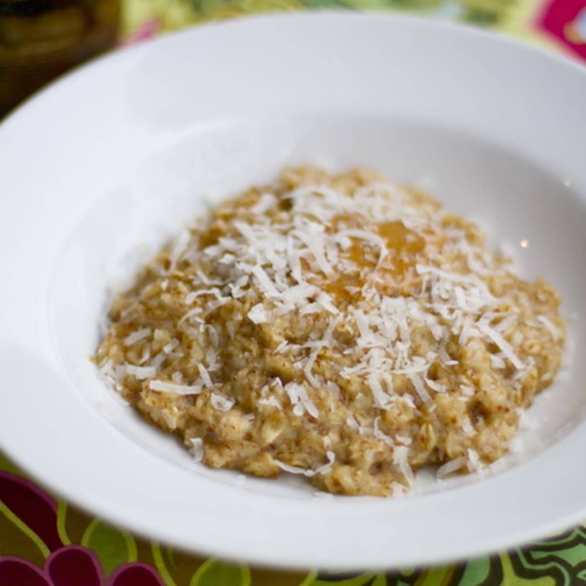 Coconut peanut butter oatmeal with coconut shreds in a white bowl.