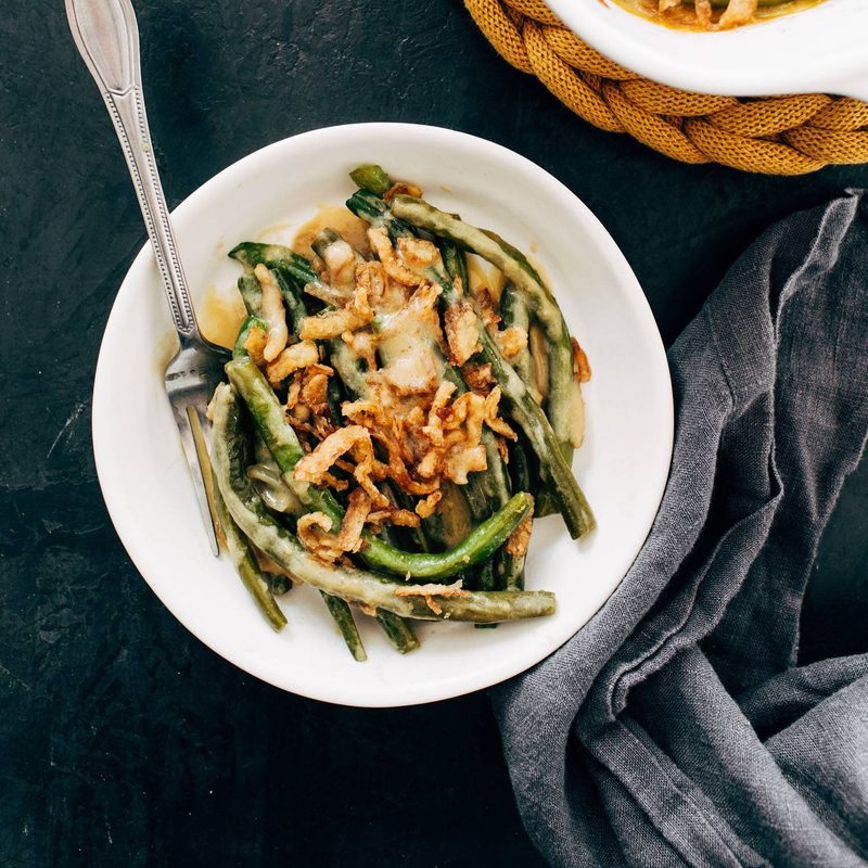 Green bean casserole on a plate with a fork.