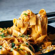 A picture of Burst Tomato Pappardelle with Zucchini, Sweet Corn, and Pan-Fried Chicken